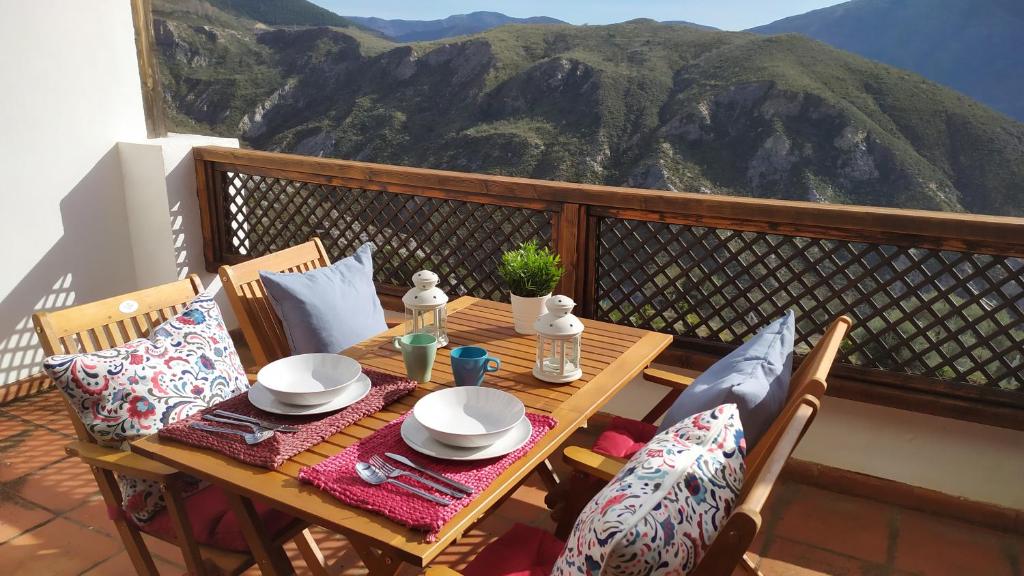 a table on a balcony with a view of a mountain at Carataunas House Alpujarra in Carataunas