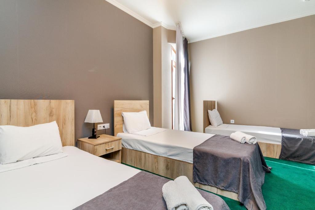 Postel nebo postele na pokoji v ubytování Hotel Marlyn
