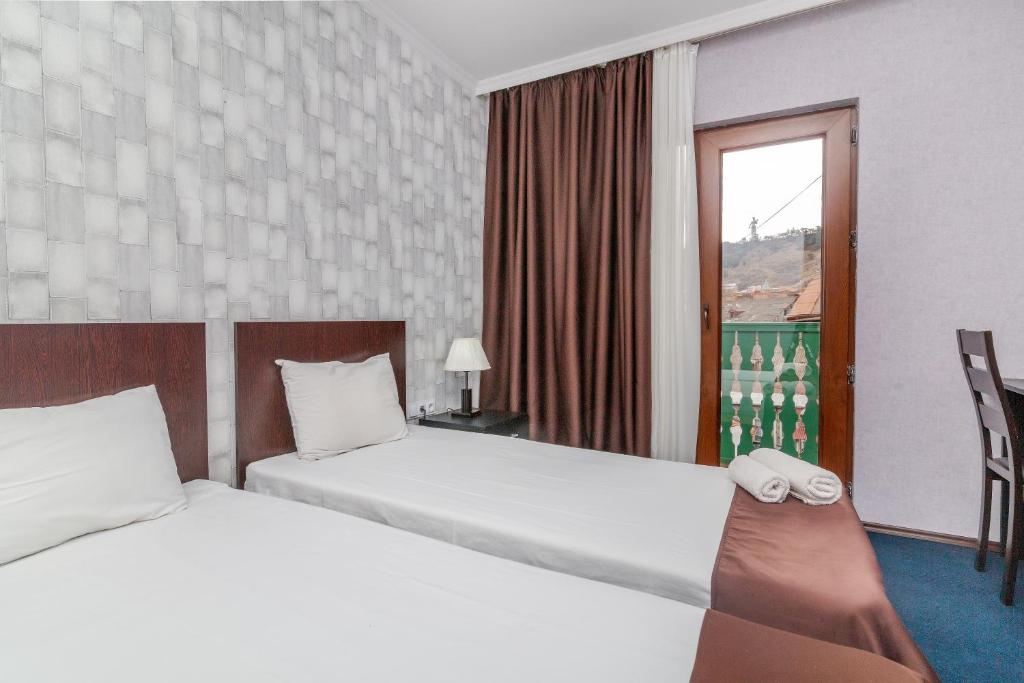 Postel nebo postele na pokoji v ubytování Hotel Marlyn