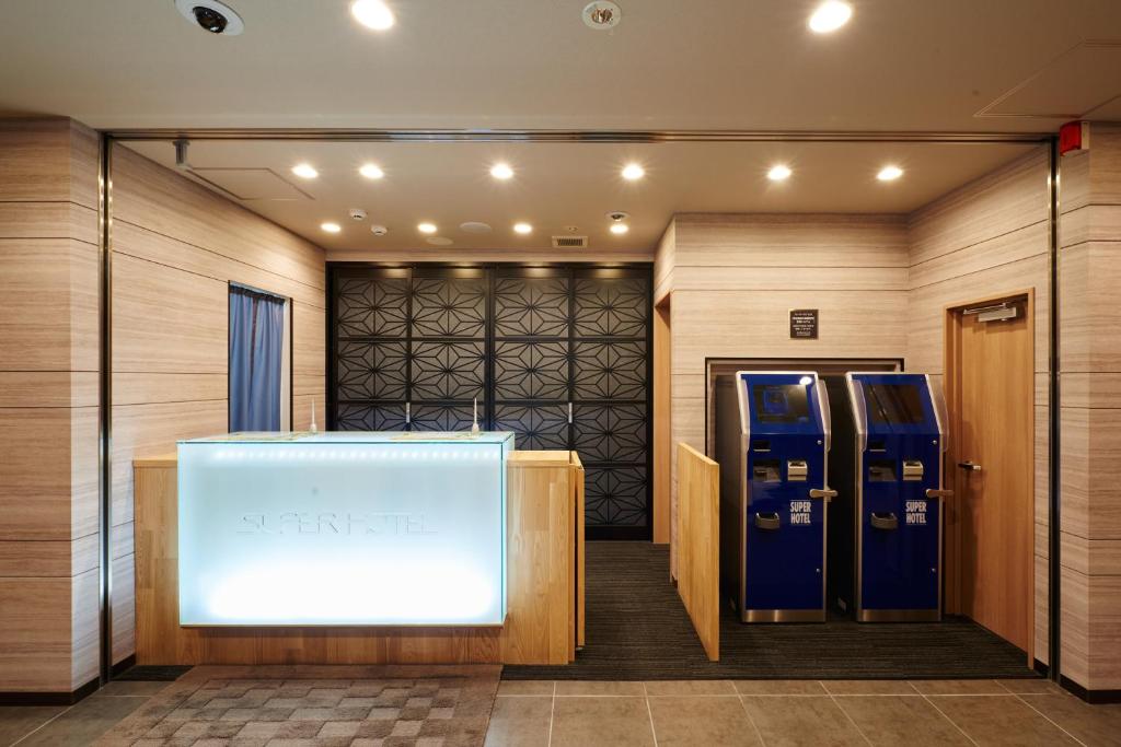a lobby with two vending machines and a window at Super Hotel Namba Nipponbashi in Osaka