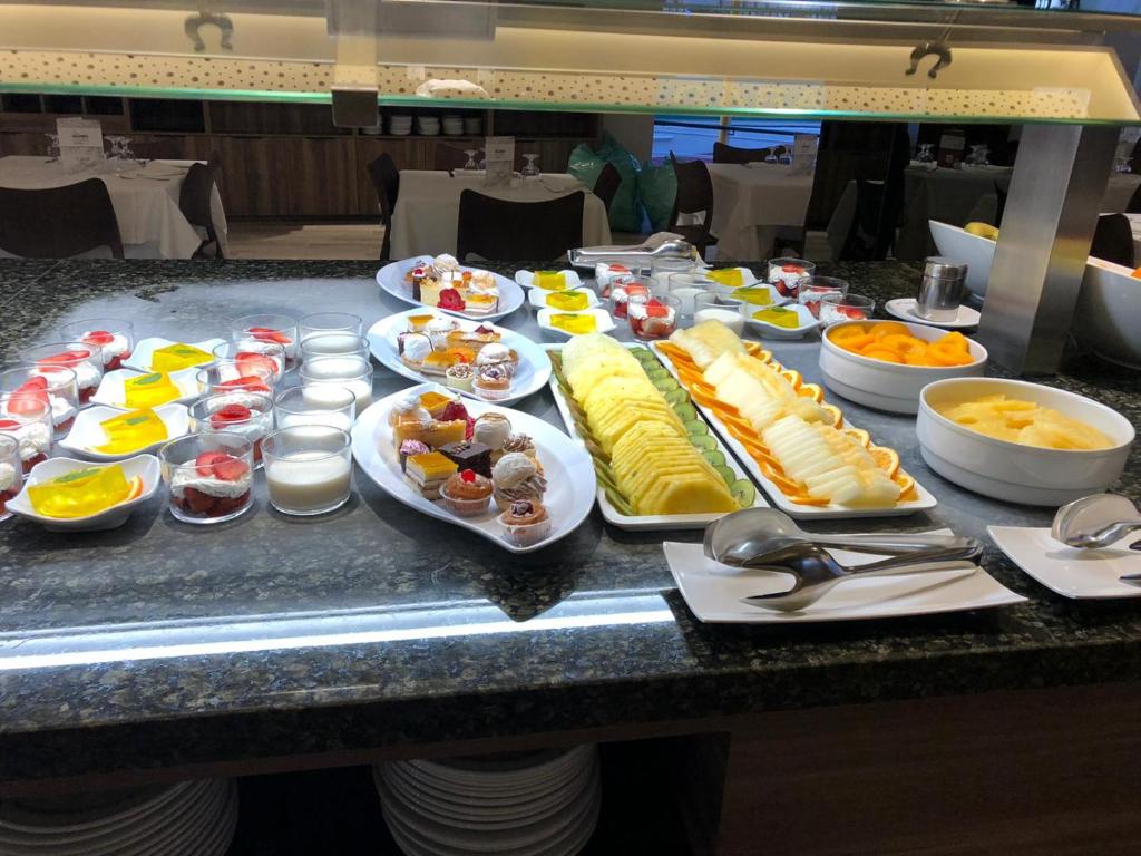 a buffet with many plates of food on a table at Les Dunes Comodoro in Benidorm