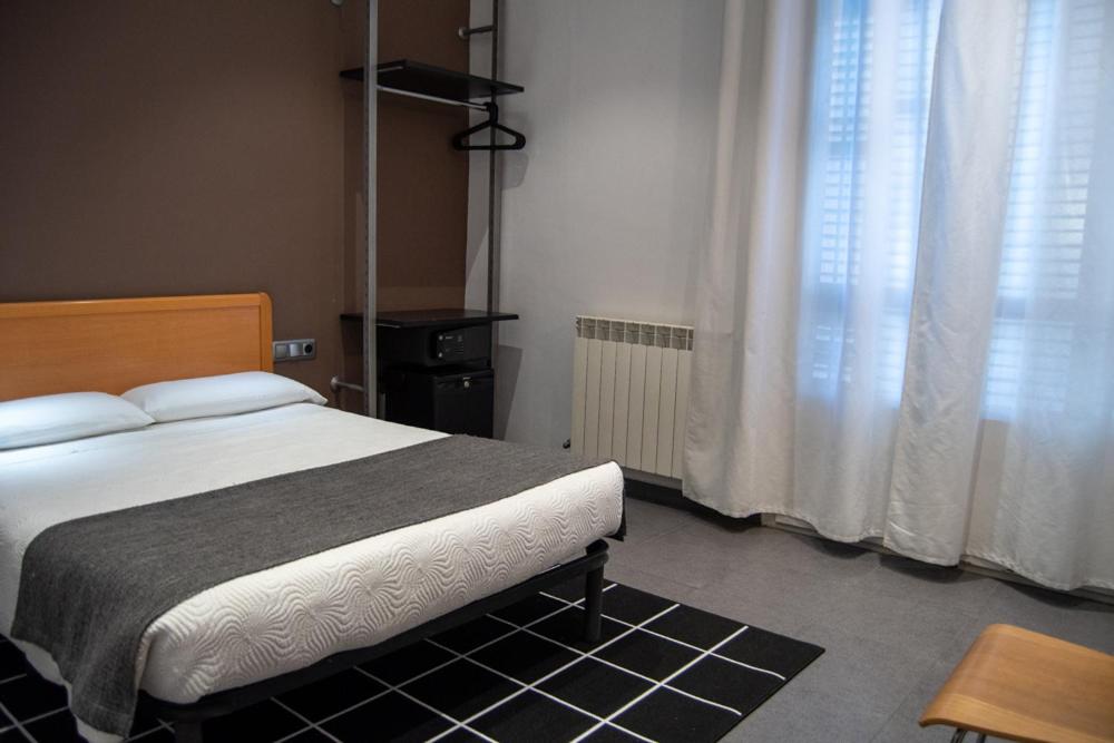 Postel nebo postele na pokoji v ubytování Hostal Apolo