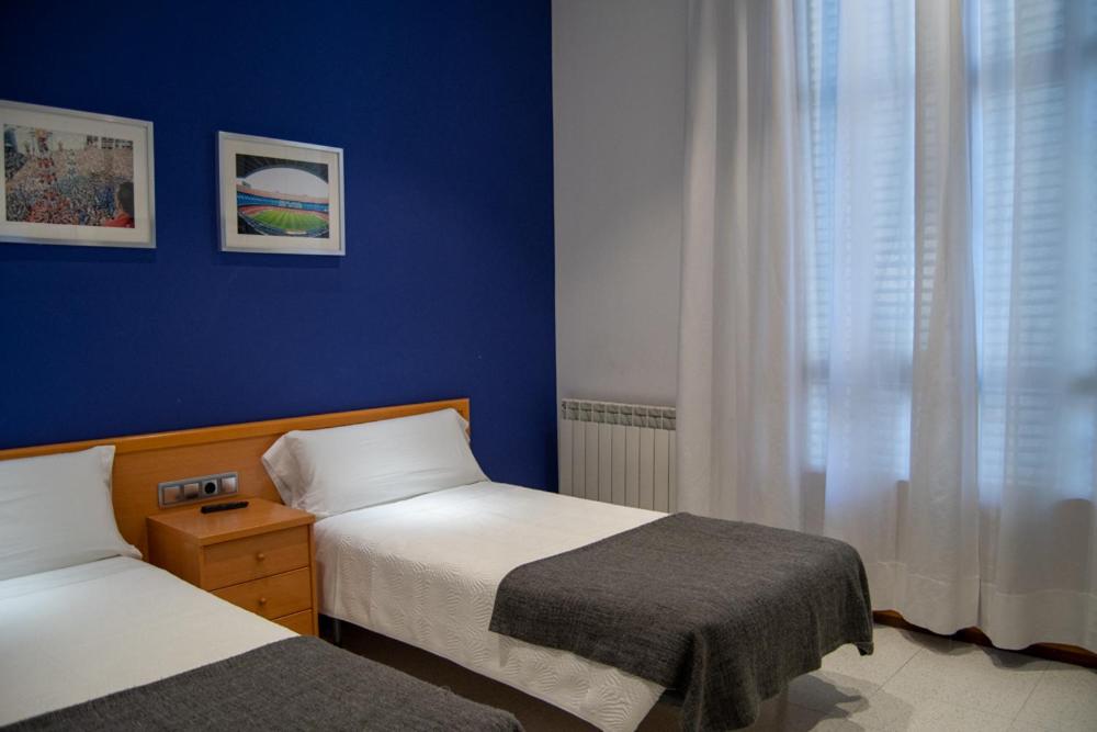 Postel nebo postele na pokoji v ubytování Hostal Apolo