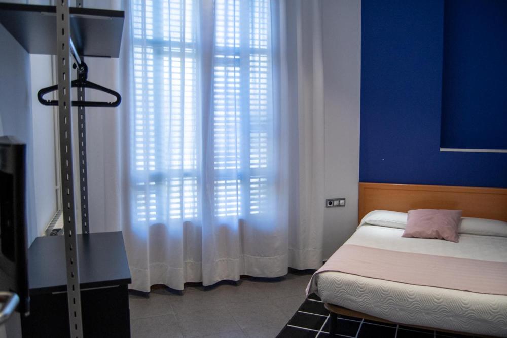 Postel nebo postele na pokoji v ubytování Hostal Apolo