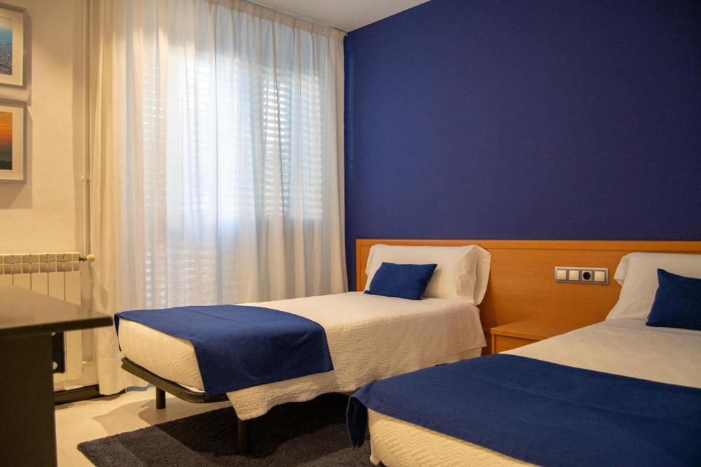 Postel nebo postele na pokoji v ubytování Hostal Apolo