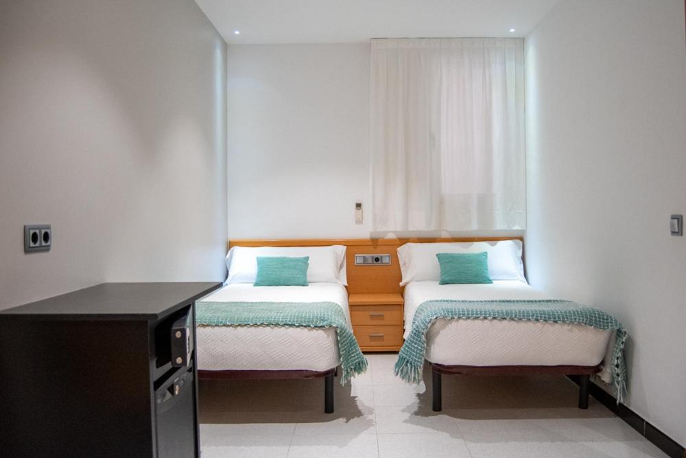 Postel nebo postele na pokoji v ubytování Hostal Apolo