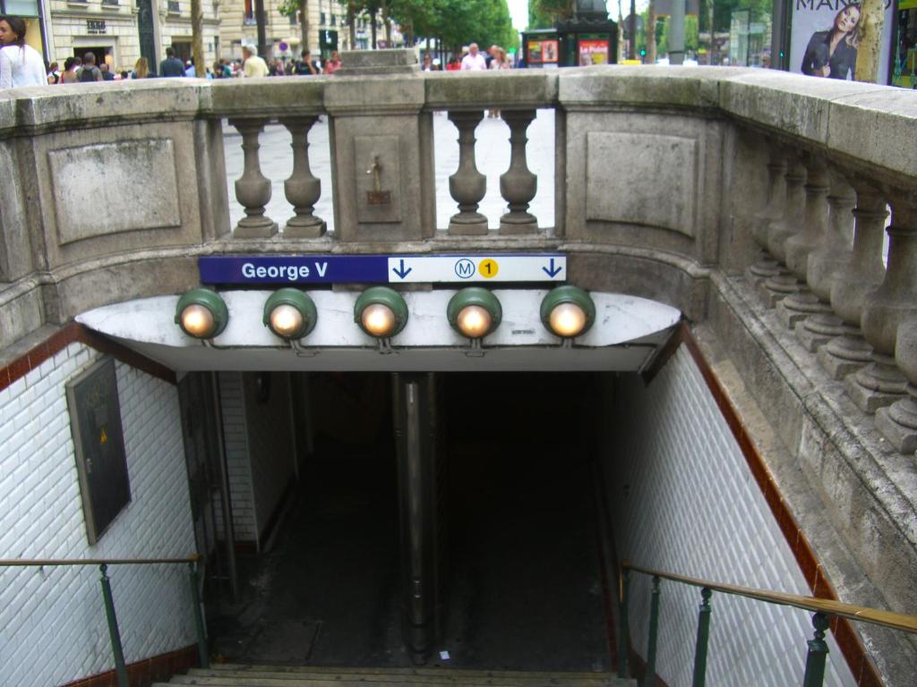 a tunnel with a subway sign on a bridge at Champs Elysees Flat in Paris