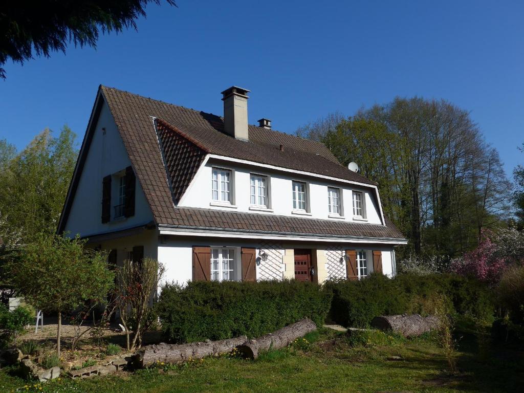een groot wit huis met een bruin dak bij Azuré Chambres d'hôtes in Orgeval