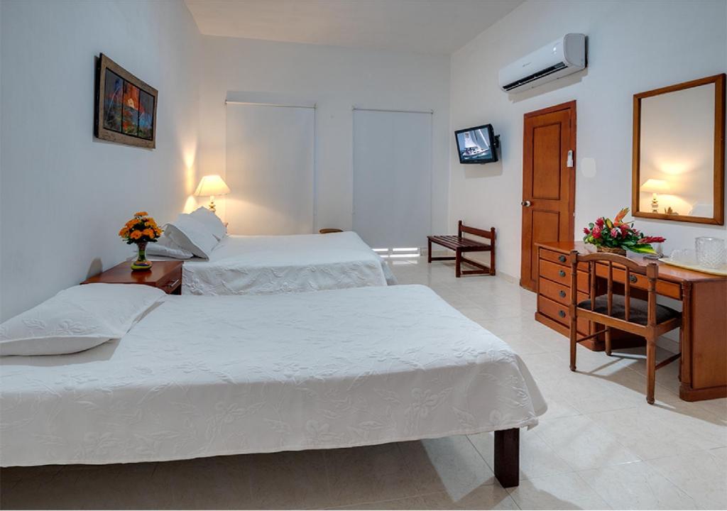 Postel nebo postele na pokoji v ubytování Hotel Dorado Plaza Centro Histórico