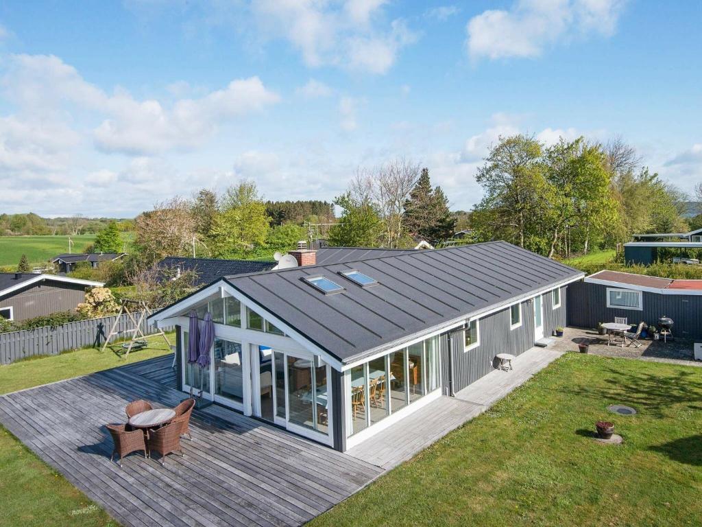 a house with a solarium on a deck at 6 person holiday home in B rkop in Børkop