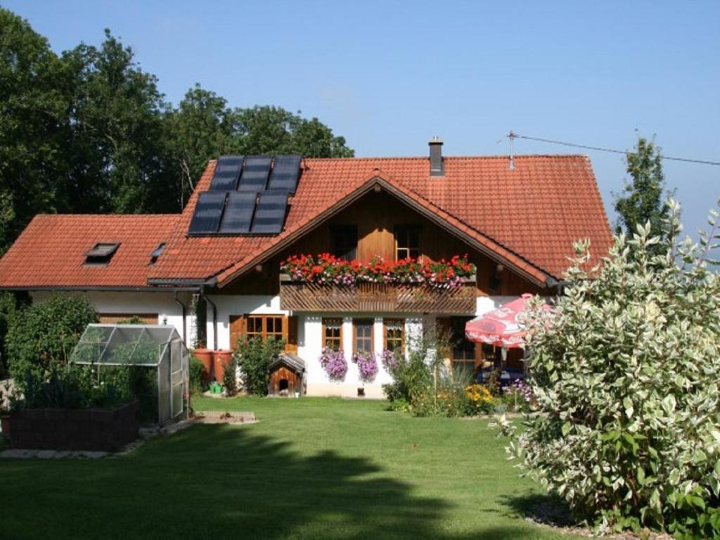 una casa con techo con paneles solares en Ferienwohnung Angelika Neuner, en Sulzberg