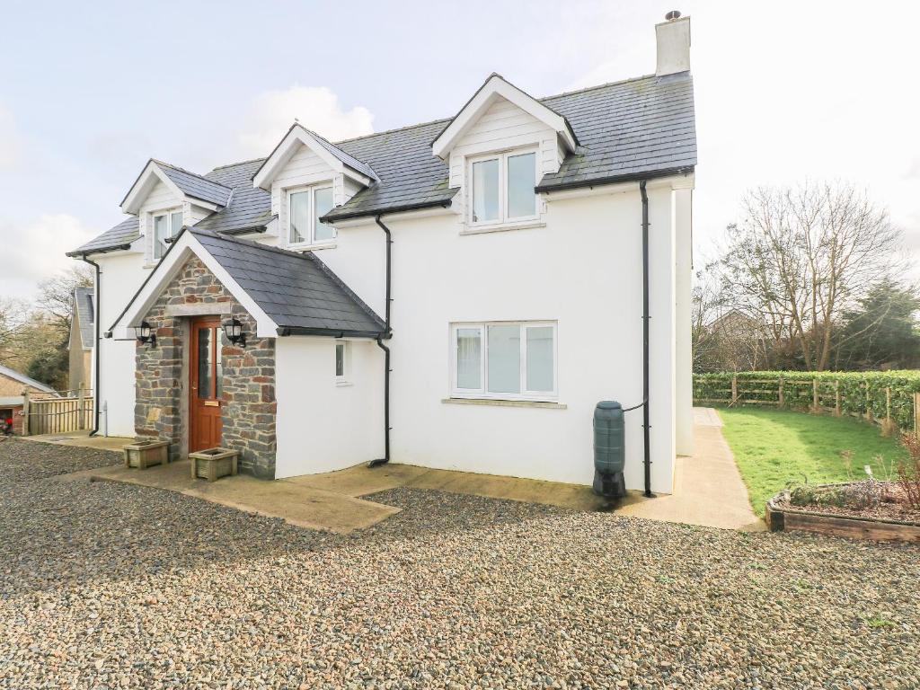 a white house with a driveway at The Laurels in Haverfordwest