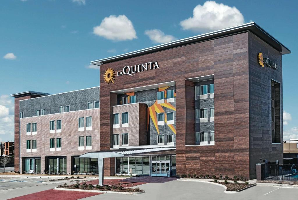 a rendering of a building with a hotel at La Quinta by Wyndham Dallas Grand Prairie North in Grand Prairie