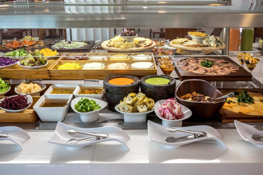 a buffet line with many different types of food at Barceló Corralejo Sands in Corralejo