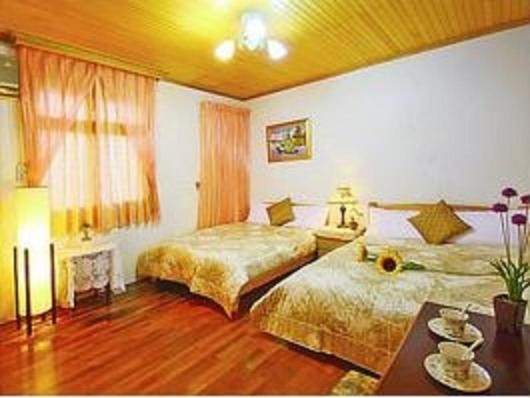 a hotel room with two beds and a table at Yilan Affectivity in Wujie