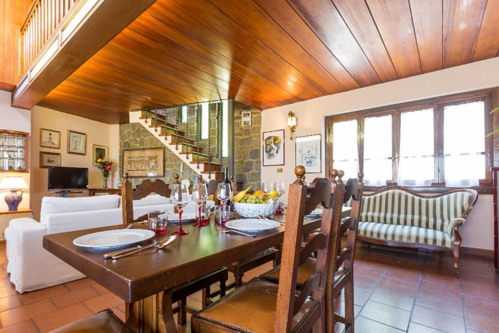 une salle à manger avec une table et un salon dans l'établissement Panoramic View Village of Villa Luigina Cortona, à Castiglion Fiorentino