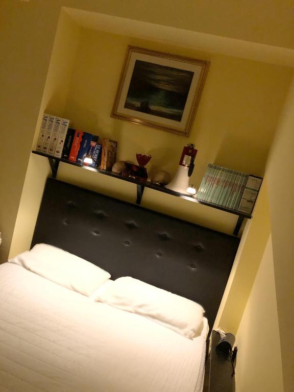 a bedroom with a bed and a shelf on the wall at Luna in Fondachello