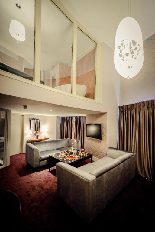 a living room with a couch and a table at Osprey Hotel in Naas