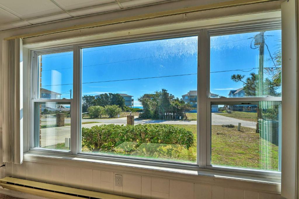 a window with a view of a street at 1 Ocean Fun Emerald Isle Apt, Steps to Beaches! in Emerald Isle