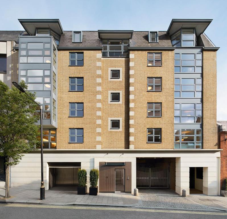 un edificio de apartamentos con un garaje delante de él en COMO Metropolitan London Residences en Londres