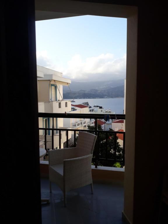 a balcony with a chair and a view of the water at Amaryllis Hotel in Karpathos