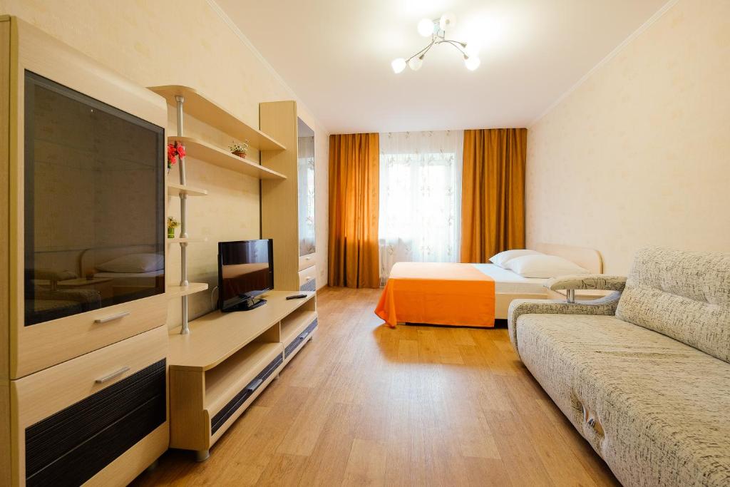 a hotel room with a bed and a tv at OK! Советская 98 №1 in Tomsk