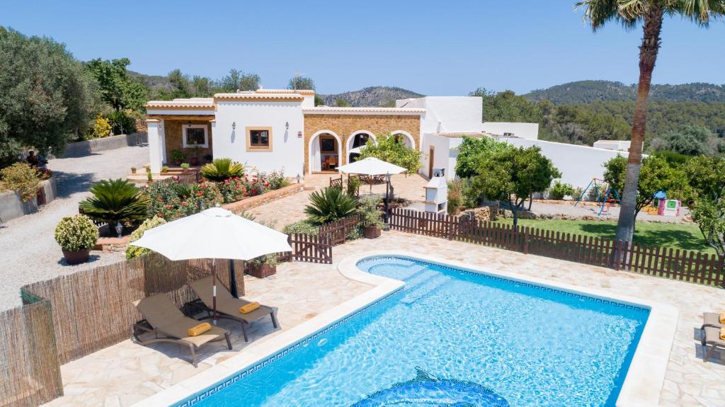 a villa with a swimming pool and a house at Villa Can Juano in Sant Miquel de Balansat