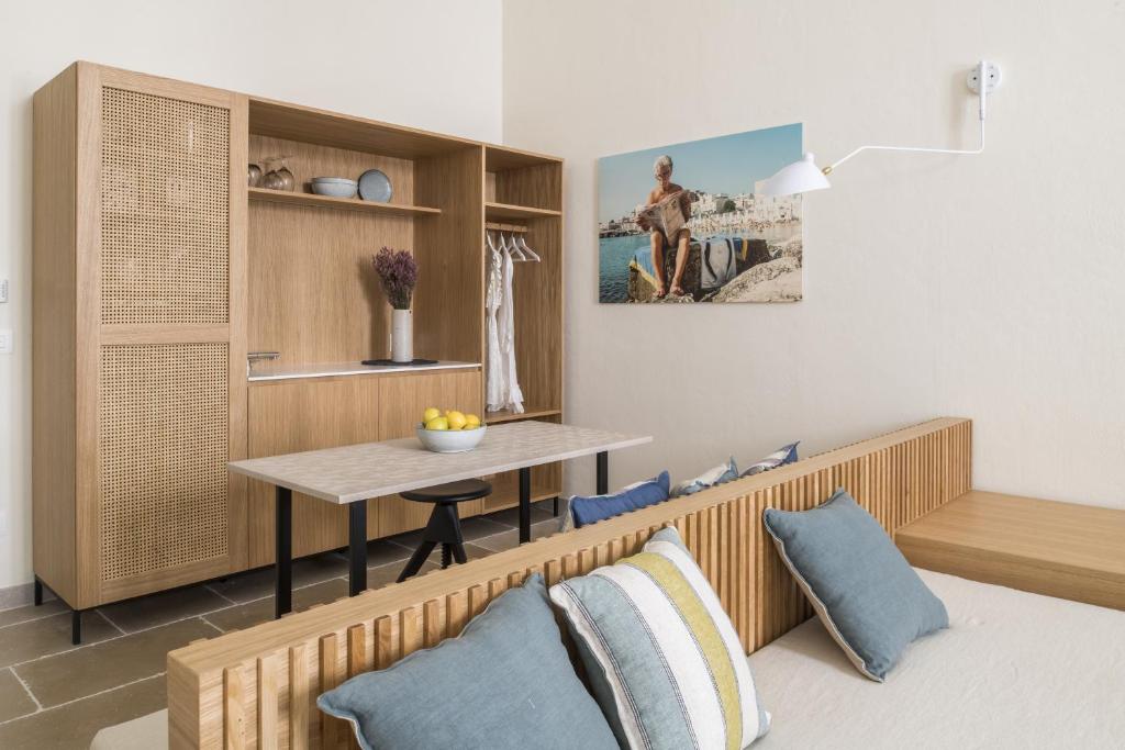 a living room with a table and a dining room at Palazzo Mulini in Monopoli