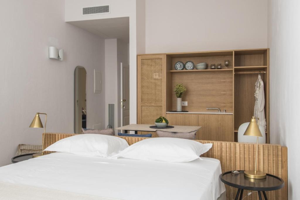 a bedroom with two beds and a kitchen at Palazzo Mulini in Monopoli
