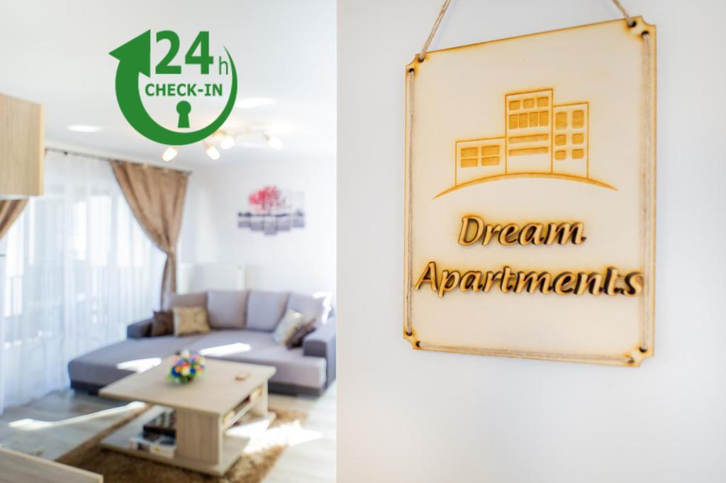 a living room with a blue couch and a sign that reads dream apartments at Dream Apartments Brasov in Braşov