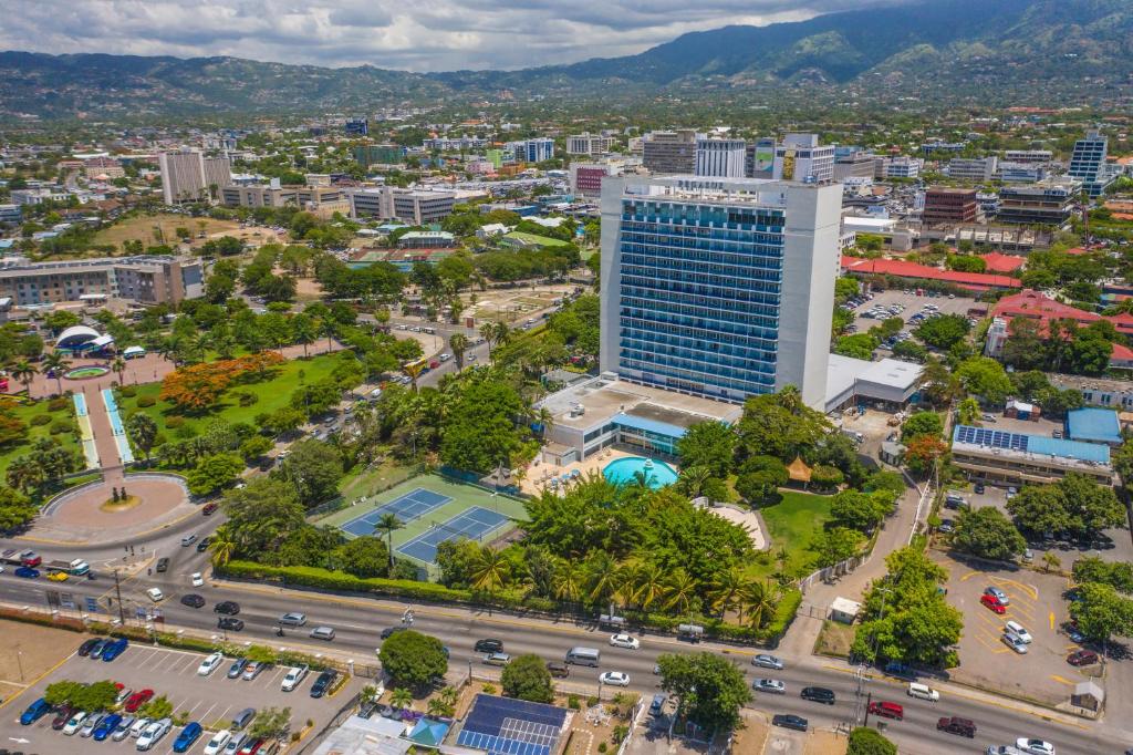 an aerial view of a city with a tall building at The Jamaica Pegasus Hotel in Kingston