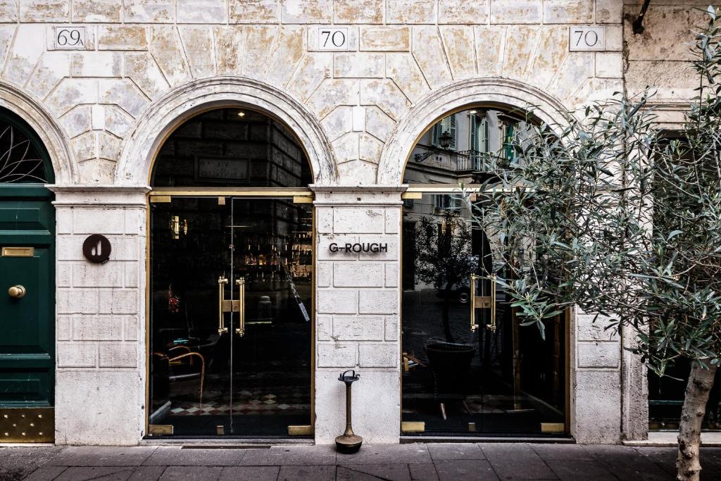 an entrance to a store with two arched doors at G-Rough, Rome, a Member of Design Hotels in Rome