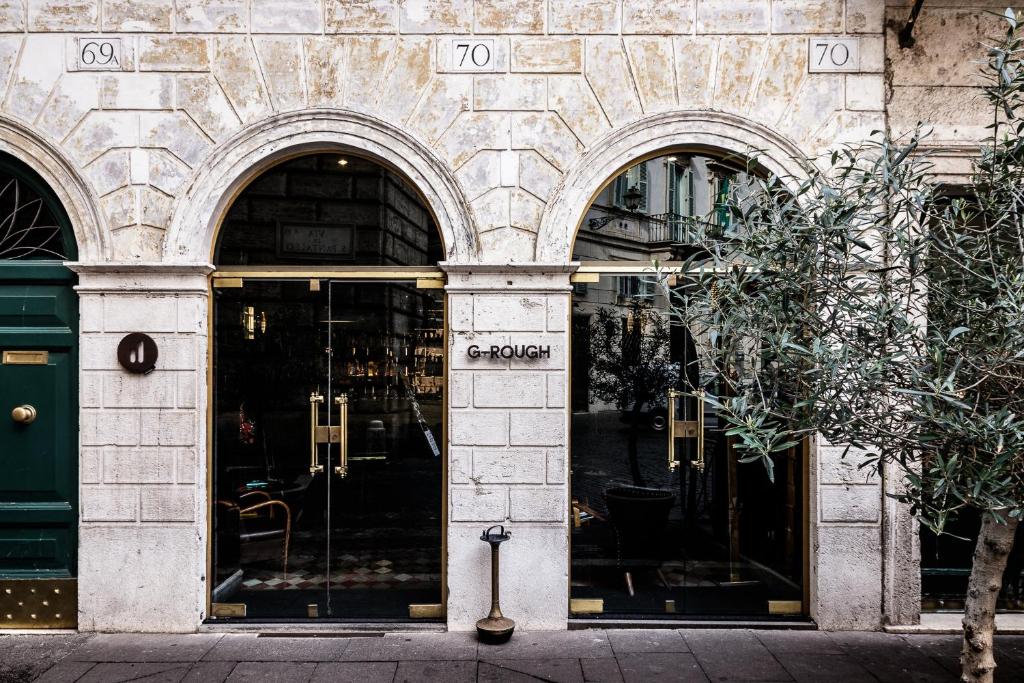 wejście do sklepu z dwoma łukowymi drzwiami w obiekcie G-Rough, Rome, a Member of Design Hotels w Rzymie