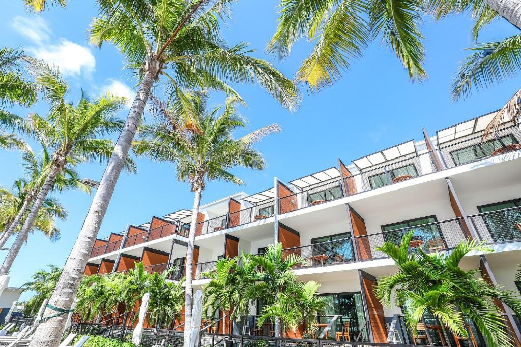 a hotel with palm trees in front of it at The Perry Hotel & Marina Key West in Key West