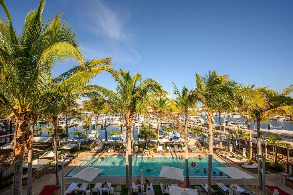 an aerial view of a resort with a pool and palm trees at The Perry Hotel & Marina Key West in Key West