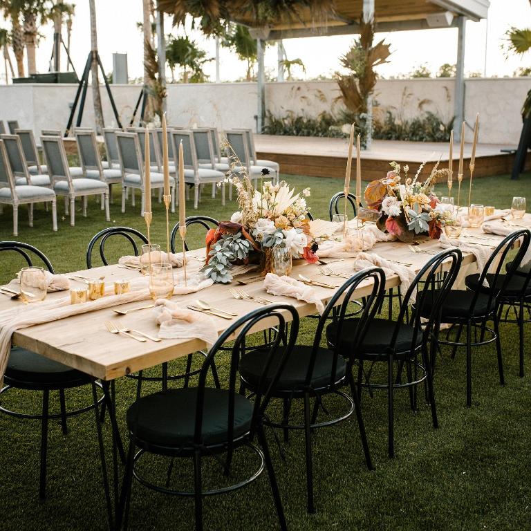 a long table with chairs and flowers on it at The Perry Hotel & Marina Key West in Key West