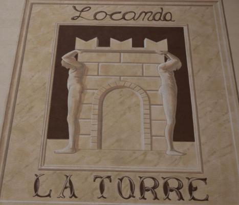 a picture of two men standing on a brick wall at Locanda la torre in Calvisano