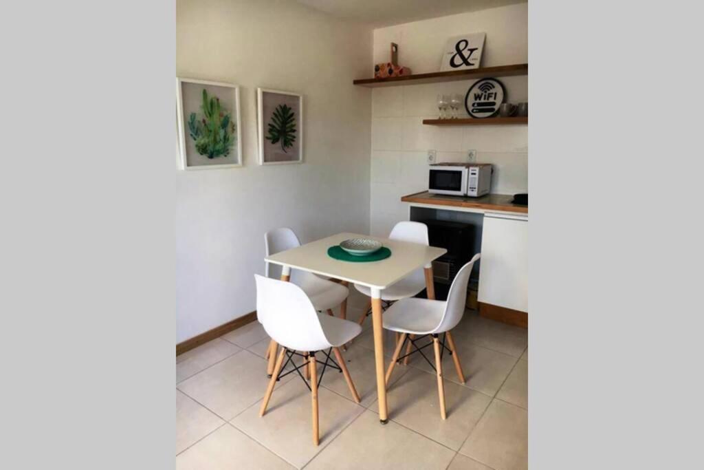 a small kitchen with a table and chairs at Apto céntrico con wifi in Colonia del Sacramento