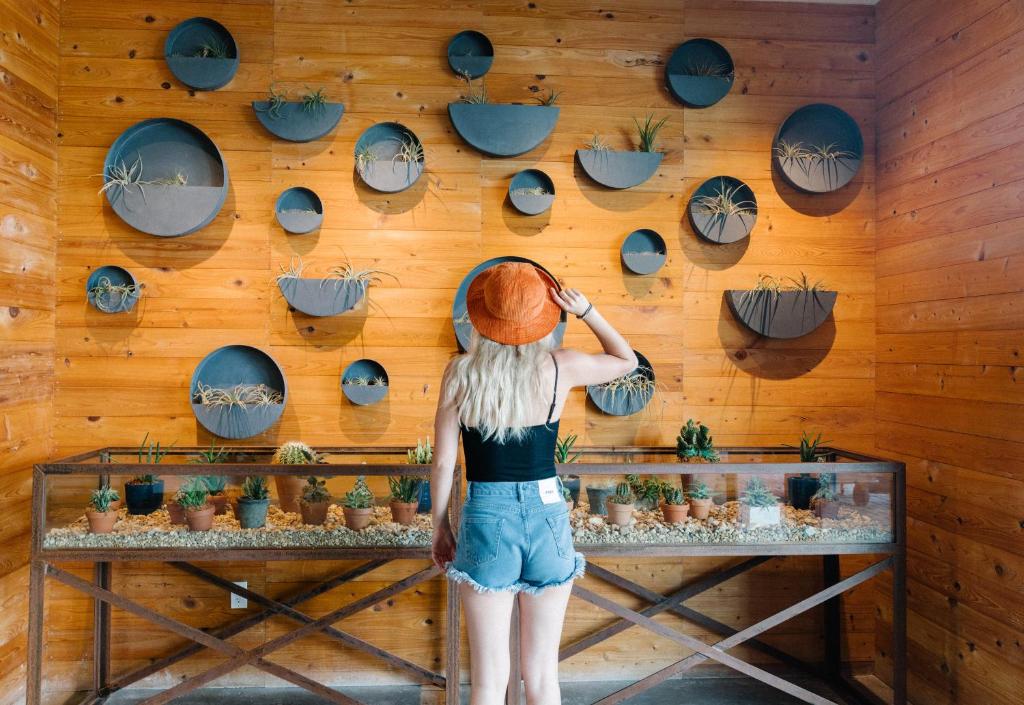a woman is looking at a wall of hats at The Perry Hotel & Marina Key West in Key West