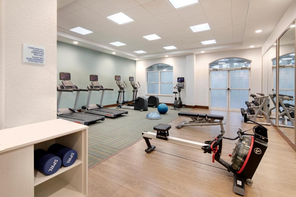 a fitness room with treadmills and weights at Holiday Inn Express & Suites S Lake Buena Vista by IHG in Kissimmee