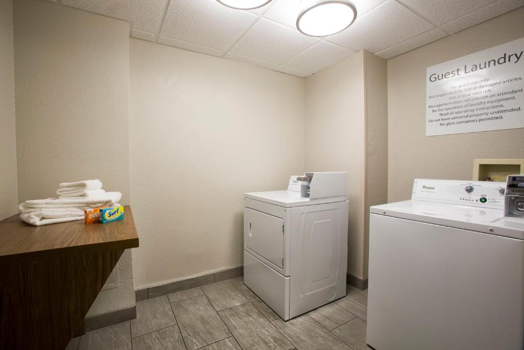 a laundry room with a washer and dryer at Holiday Inn Express & Suites S Lake Buena Vista by IHG in Kissimmee