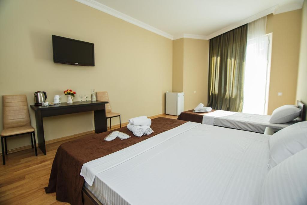 Postel nebo postele na pokoji v ubytování Hotel Egrisi