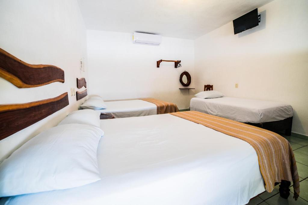 Postel nebo postele na pokoji v ubytování Hotel el Manglar