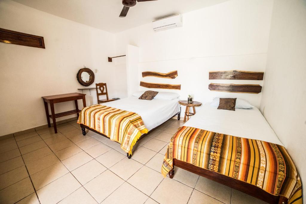 Postel nebo postele na pokoji v ubytování Hotel el Manglar