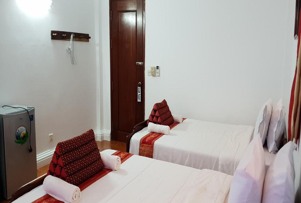 Postel nebo postele na pokoji v ubytování Smiley's Guesthouse