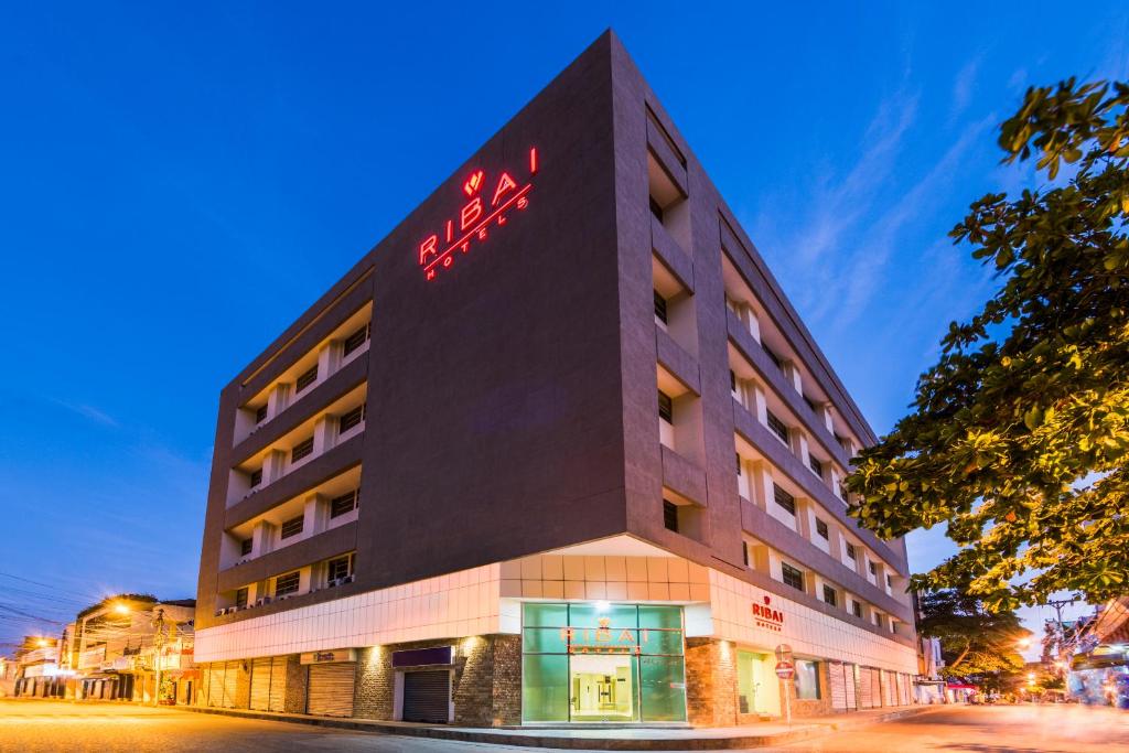 a building with a sign on the side of it at Ribai Hotels - Barranquilla in Barranquilla