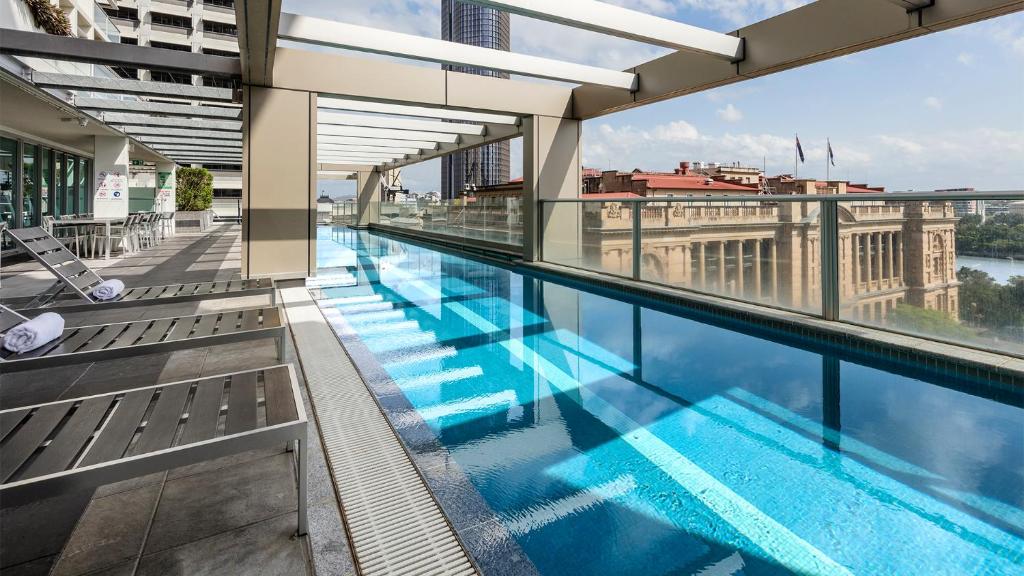 a large swimming pool on the roof of a building at Oaks Brisbane Casino Tower Suites in Brisbane