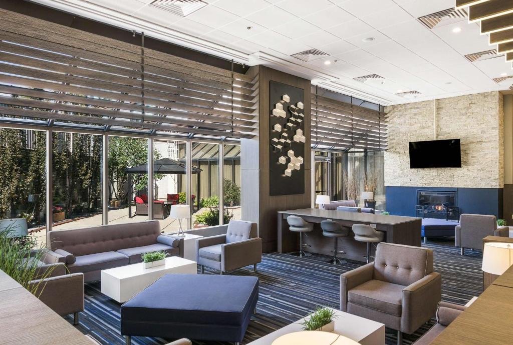 カルガリーにあるBest Western Premier Calgary Plaza Hotel & Conference Centreの建物内のソファとバーのあるロビー