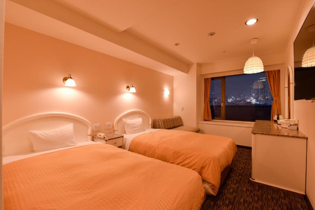 Postel nebo postele na pokoji v ubytování Kobe Sannomiya Union Hotel