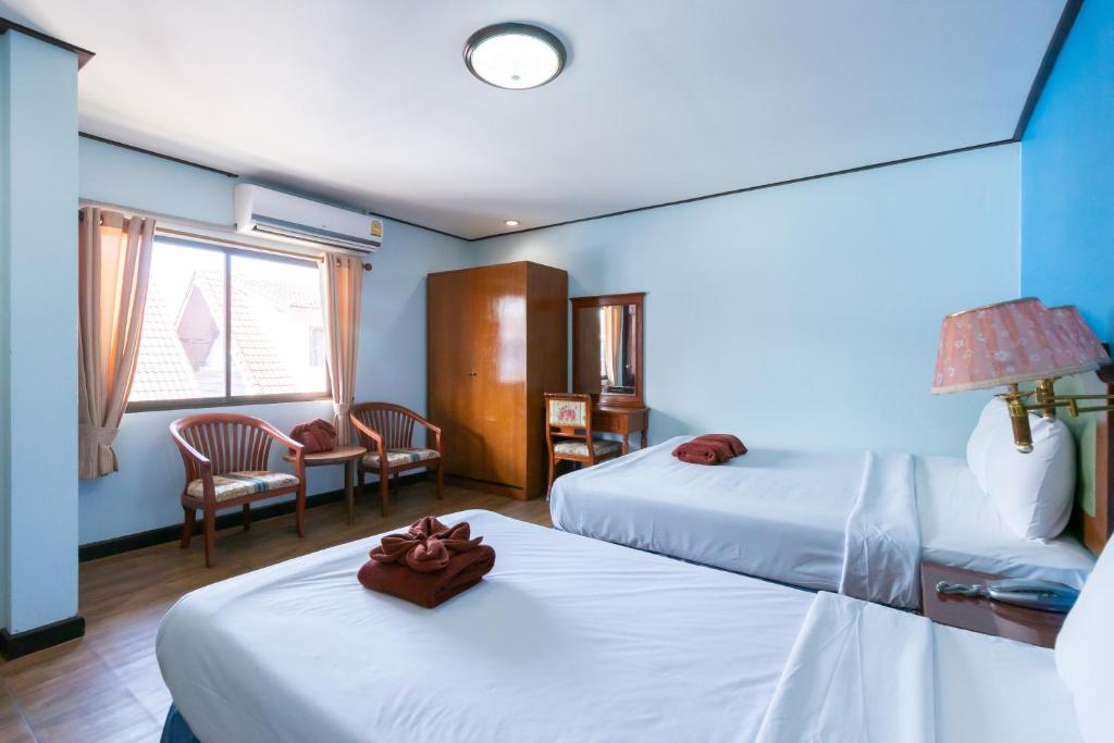 Postel nebo postele na pokoji v ubytování Thipurai Annex Hotel